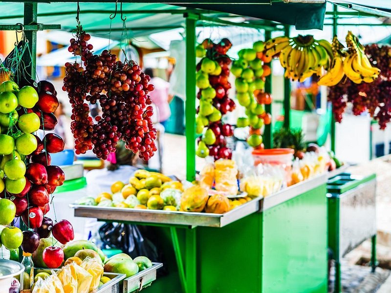 A produce stall stacked with tropical fruit at a Bogota market